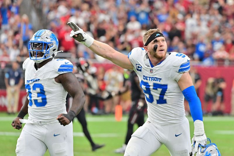Sep 22, 2024; Glendale, Arizona, USA; Detroit Lions defensive end Aidan Hutchinson (97) and defensive end Josh Paschal (93) celebrate after stopping the Arizona Cardinals on 4th and 1