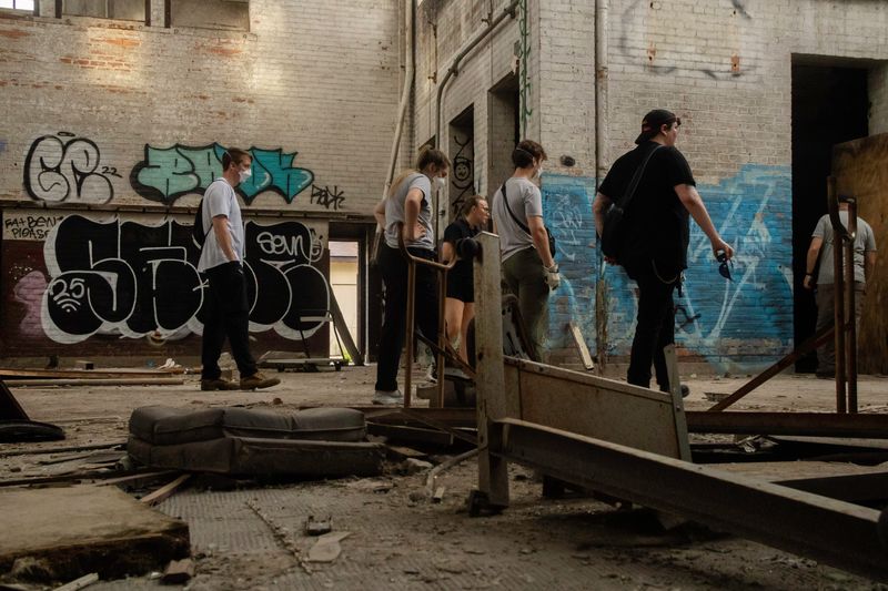Cass Tretyak, an outreach navigator with Community & Home Supports, Inc., leading her outreach and medical team through an abandoned building that is known to be used by the unhoused on June 24, 2025.