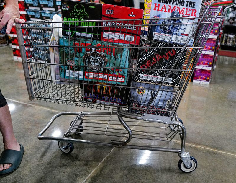 A customer's cart is pretty full of various fireworks types at Big Fireworks in Watertown Township Saturday, June 28, 2025.