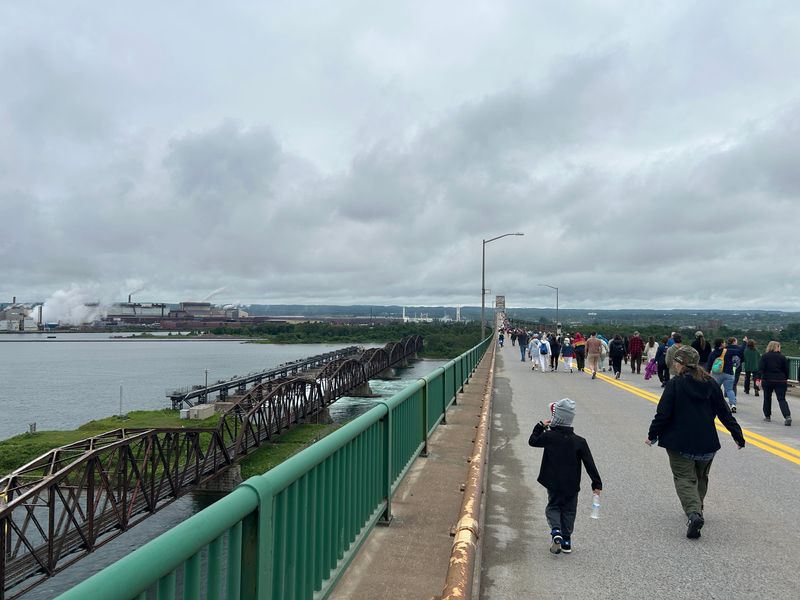 People look out on the St. Marys River and the Soo Locks during the International Bridge Walk on Saturday, June 28, 2025.