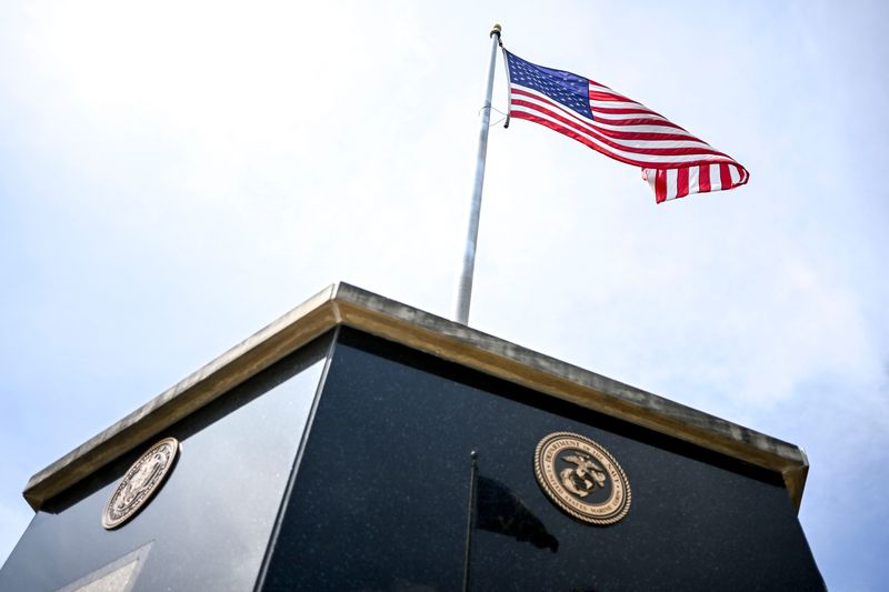 The flag flies above the memorial to veterans of all the military branches at the Veterans Memorial Gardens on Monday, June 30, 2025, in Delhi Township.