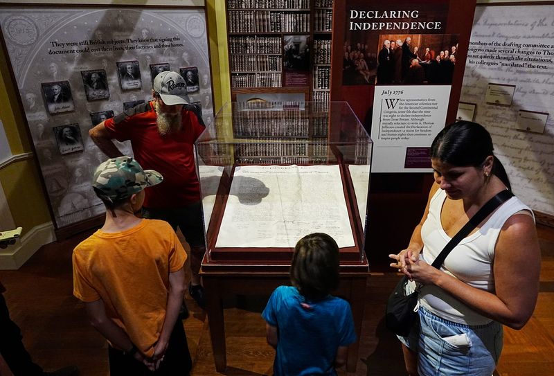 A family views a copy of the Declaration of Independence on display at The Henry Ford Museum at the “With Liberty and Justice for All” exhibit in Dearborn on Tuesday, June 24, 2025.