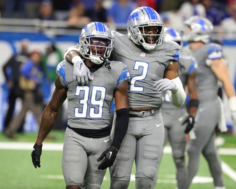 Detroit Lions cornerback Jerry Jacobs (39) and linebacker Austin Bryant (2) walk off the field during second half action at Ford Field Thursday, November 24, 2022.
