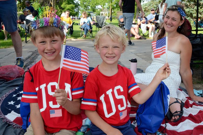 (From left) Joshua, Bryce and Stephanie Vandecar of Elmira find seats along the parade route in downtown Petoskey on Friday, July 4, 2025.