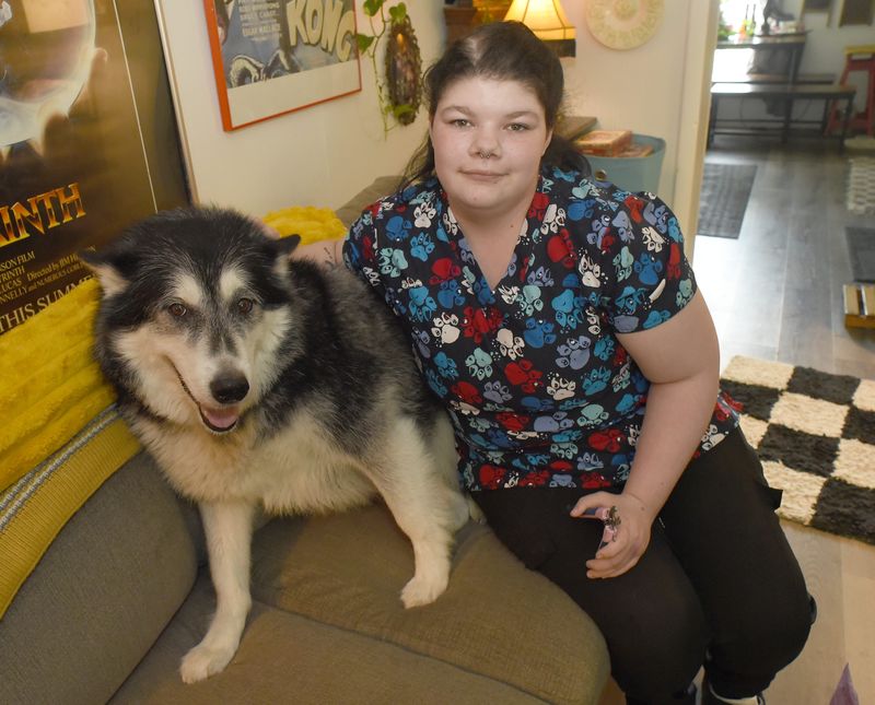 Gabbie White, owner of Gabbie's Bath & Brush Dog Grooming, is ready to trim the nails on Coda, an Alaskan malamute in the home of Sam Robertson in Dundee.