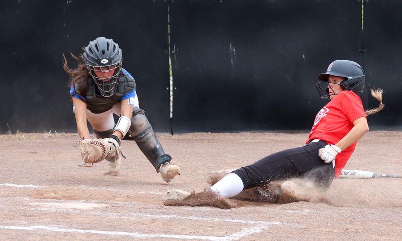 St. Mary Catholic Central catcher Tori Busen and Monroe's Avery Leach race to home plate during a 7-6 win by the Red team in the Monroe County All-Star Softball game on Monday, July 7, 2025.