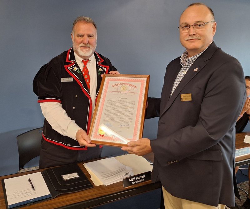 Otsego County Administrator Matt Barresi (left) accepts a state of Michigan tribute to him from Robert Pallarito, district director for State Rep. Michele Hoitenga (R-Manton) in Gaylord on Tuesday, July 8, 2025.