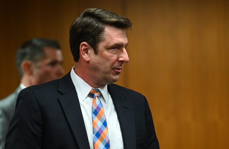 Former Lansing Police Department Lieutenant Ryan Wilcox enters Judge Cynthia Ward's courtroom, Thursday, May 1, 2025, during his sentencing hearing in district court. Also pictured is his attorney Nathaniel Pfeiffer.