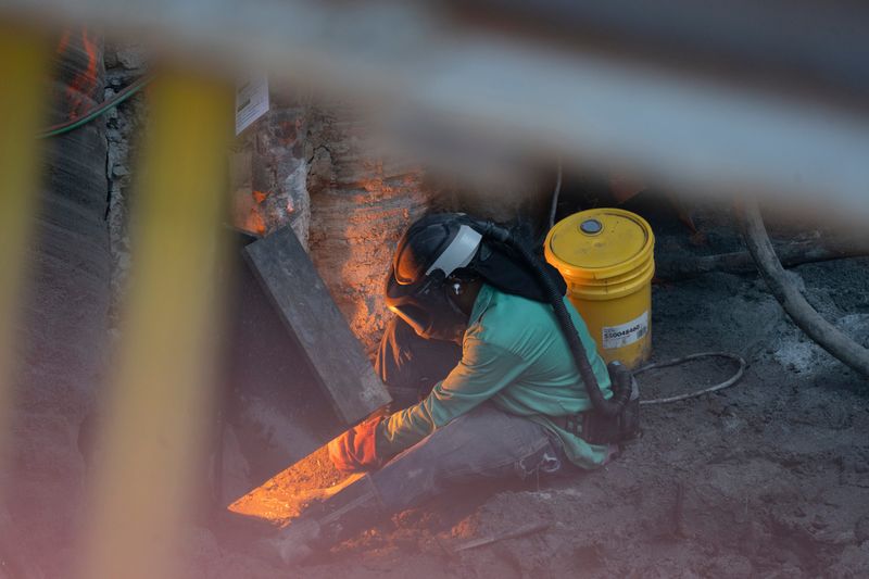A construction worker welds in an 80-foot deep hole on site of the Hudson Yards Concrete Casing Project in Manhattan, NY on Tuesday, July 8, 2025. This project extends the current concrete casing for the new tunnels.