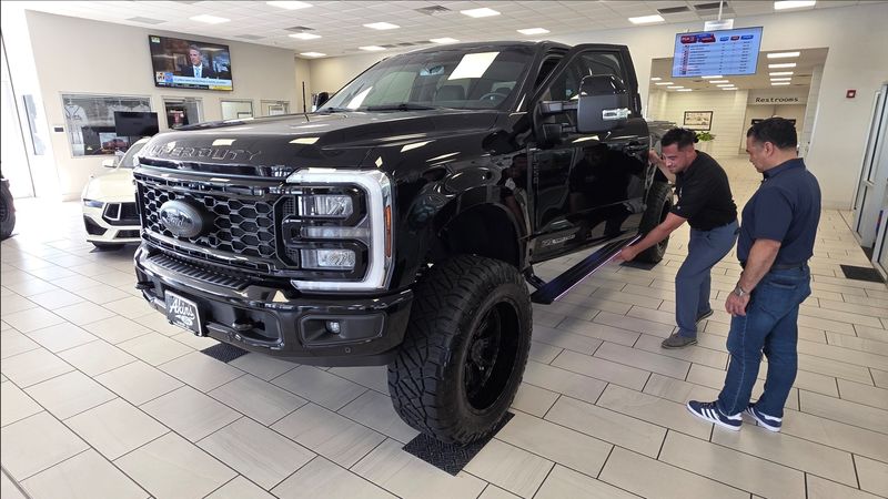 A salesperson at Akins Ford showroom in Winder, Georgia, goes over the features of the Ford F-150 Super Duty in July 2025. Ford's "From America, For America" employee pricing for all was a hit that helped boost second quarter sales.