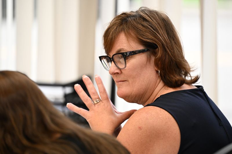 Former Adams Township Clerk Stephanie Scott listens to her attorney, Kurt Olsen, as he questions Michigan Director of the Bureau of Elections Jonathan Brater during a preliminary examination for Scott and Oakland County attorney Stephanie Lambert, who have been charged with a voter data breach stemming from the 2020 election. The hearing was held at the Hillsdale County Courthouse Annex, Friday, July 11, 2025 after being delayed for more than a year because of their efforts to have the case thrown out in a higher court.