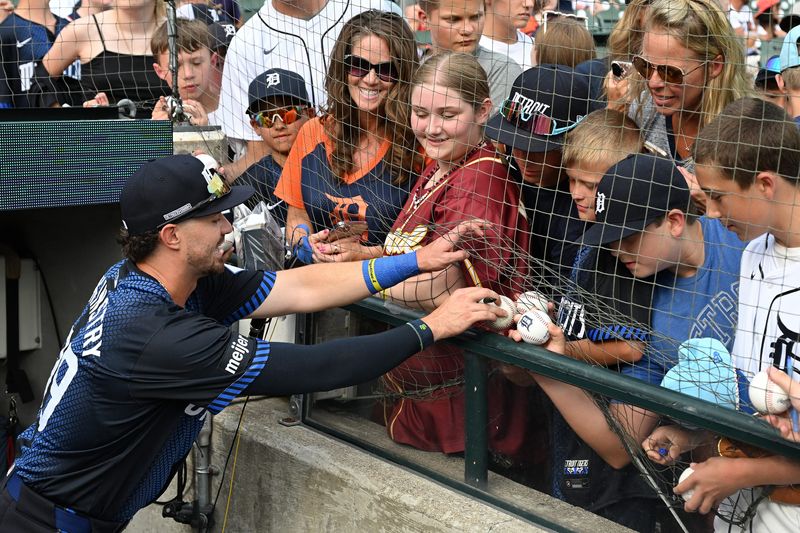 Detroit Tigers third baseman Zach McKinstry (39) signs autographs for fans before their game against the Seattle Mariners in the first inning at Comerica Park in Detroit on Friday, July 11, 2025.