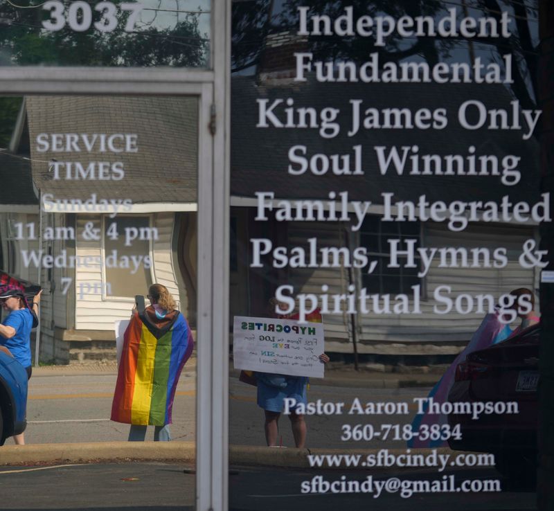 Protesters gather Sunday, July 13, 2025, outside Sure Foundation Baptist Church near Lafayette Road and West 30th Street in Indianapolis. Supporters of the LGBTQ+ community gathered to protest after a sermon was delivered at the church encouraging the deaths of those who identify as LGBTQ+.