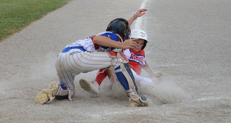 Ida catcher Grant Letellier tags out Seager Stark at the plate during a 7-5 Monroe victory on the opening day of the 65th annual Monroe County Fair Baseball Tournament on Sunday, July 13, 2025.