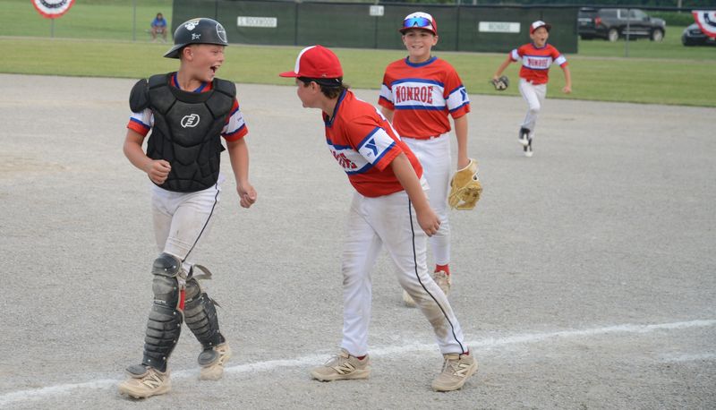 Monroe catcher Tad Schuyler and pitcher Charles Bailey celebrate a 7-5 win over Ida on the opening day of the 65th annual Monroe County Fair Baseball Tournament on Sunday, July 13, 2025.