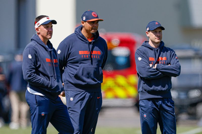 May 9, 2025; Lake Forest, IL, USA; Chicago Bears defensive coordinator Dennis Allen (L), general manager Ryan Poles (C) and head coach Ben Johnson (R) observe during the Rookie Minicamp at Halas Hall