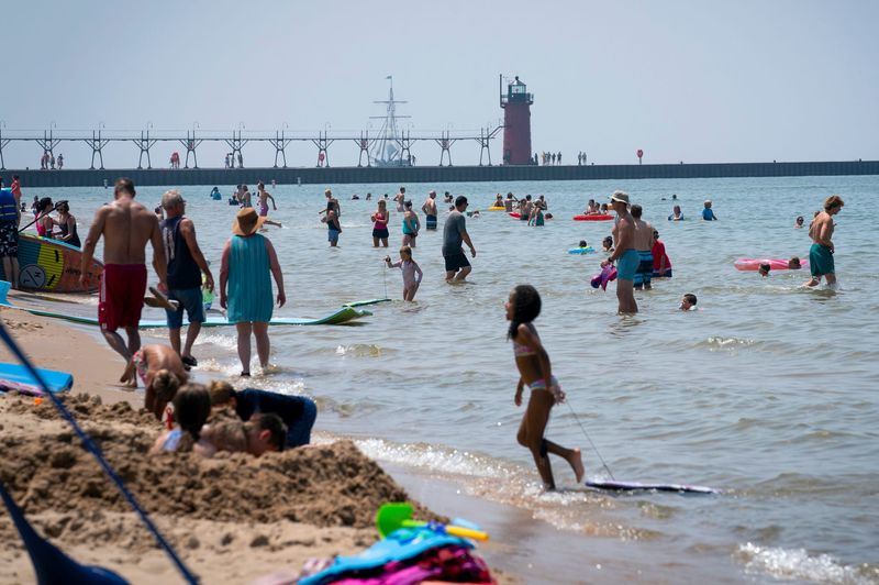 Beachgoers in South Haven swim in Lake Michigan at their own risk on Tuesday, July 15, 2025. Lake Michigan is the deadliest lake in America, statistics show. Yet there are no lifeguards at 99% of Michigan's public beaches.