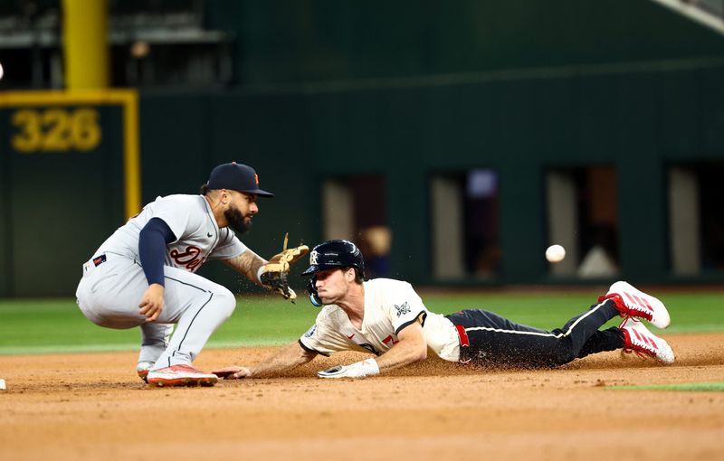 Detroit Tigers second baseman Gleyber Torres (25) tags out Texas Rangers center fielder Evan Carter (32) at second base during the second inning at Globe Life Field in Arlington, Texas, on Friday, July 18, 2025.