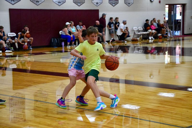 Gavin Kreauchauf, 11, dribbles a basketball during the Venetian Festival Roundball Tournament on Sunday, July 20, 2025 at Charlevoix Middle/High School.