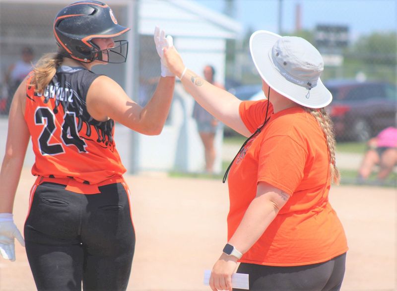 Cheboygan Chaos' Bea Schulz (24) gives a high-five to coach Avery Nowosad during a Chaos Clash softball tournament game in Cheboygan last summer. Tournament action begins in Cheboygan this Friday.