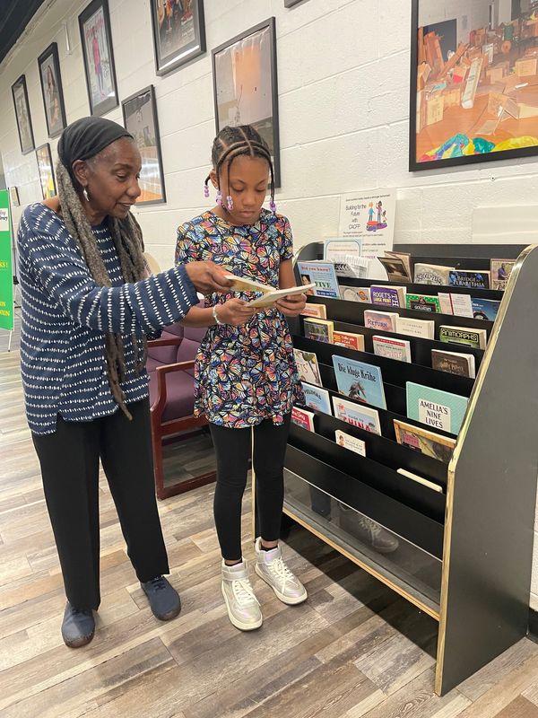 On the morning of June 22, 2025 at the Tindal Activity Center, Lena Bembery (left) was delighted to talk about books with Skyler Harris, a rising sixth grader, who attends Pepper Elementary School in Oak Park. Through her Reading Corner Library program, Bembery provides free books at locations that serve the public in Detroit and Highland Park. But on June 22, Bembery confessed that Tindal is her favorite library spot because of enthusiastic young people like Harris.