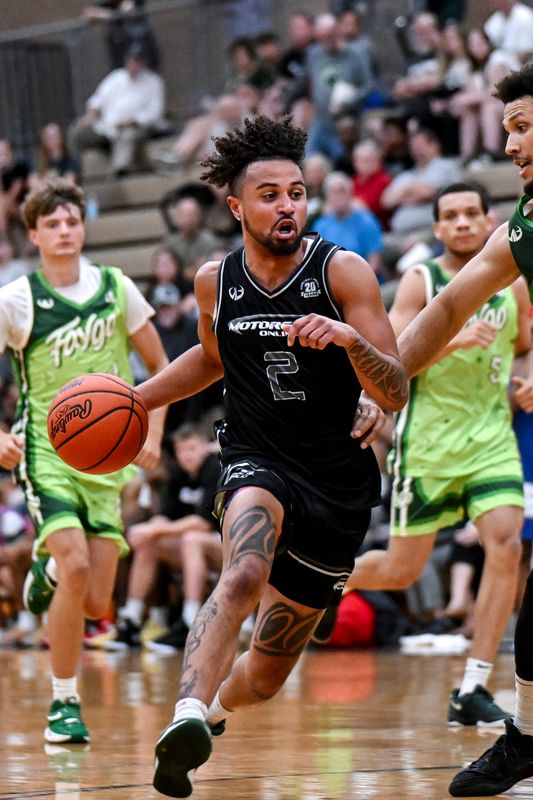 Team Motorsports' Drew Lowder drives to the basket against Team Faygo on Thursday, July 18, 2025, at Holt High School.