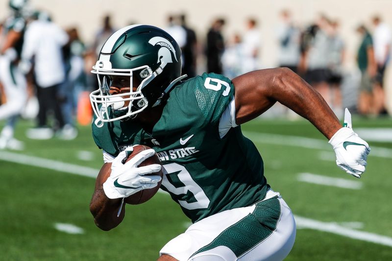 Michigan State running back Kenneth Walker III (9) sprints during warm up before the Youngstown State game at Spartan Stadium in East Lansing on Saturday, Sept. 11, 2021.