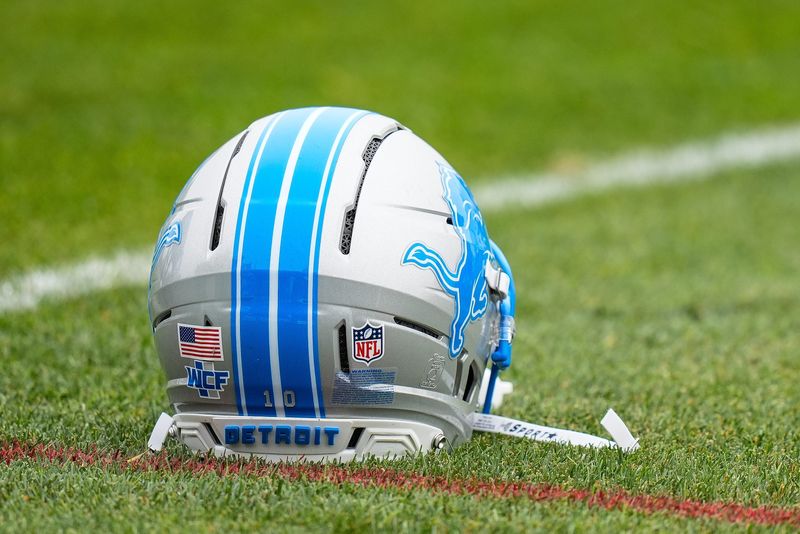The helmet of a Detroit Lions player sits on the grass during a training camp practice at Meijer Performance Center in Allen Park on Saturday, July 26, 2025.