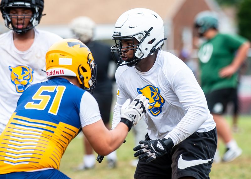 Redford Union's Devin Lillard rushes the passer during a 7-on-7 football tournament drill on Saturday, July 26, 2025, at Bob Atkins Field.
