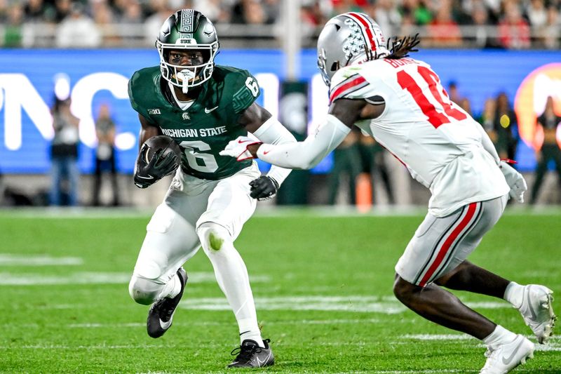 Michigan State's Nick Marsh, left, runs after a catch as Ohio State's Denzel Burke closes in during the second quarter on Saturday, Sept. 28, 2024, at Spartan Stadium in East Lansing.