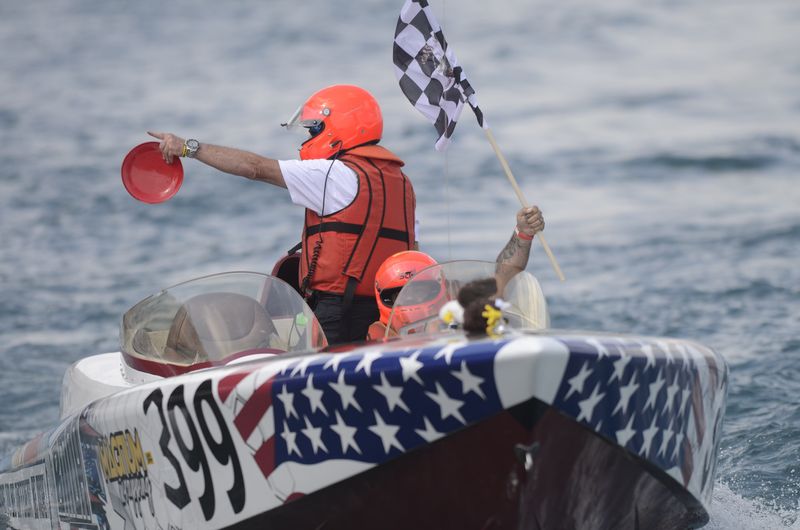 The crew of a powerboat celebrates with a checkered flag during the 31st St. Clair River Classic in St. Clair on Sunday, July 27, 2025.