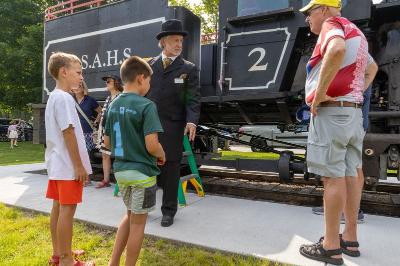 An Ephraim Shay reenactor speaks with attendees about the history of the Shay locomotive during the Shay Days event at Shay Park in Harbor Springs on Saturday, July 26, 2025.