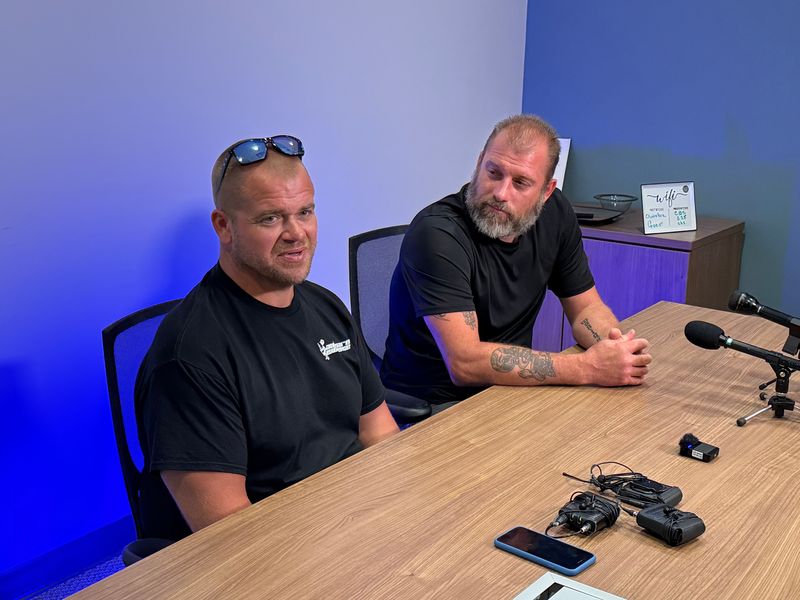 Chris O'Brien, left, and Matt Kolakowski speak to reporters on Tuesday, July 29, 2025, at Shield Investigators in Grand Rapids, Mich. The two were among those who rushed to intervene on a man later charged with terrorism and assault with intent to murder for allegedly carrying out a stabbing spree in Traverse City on July 26.