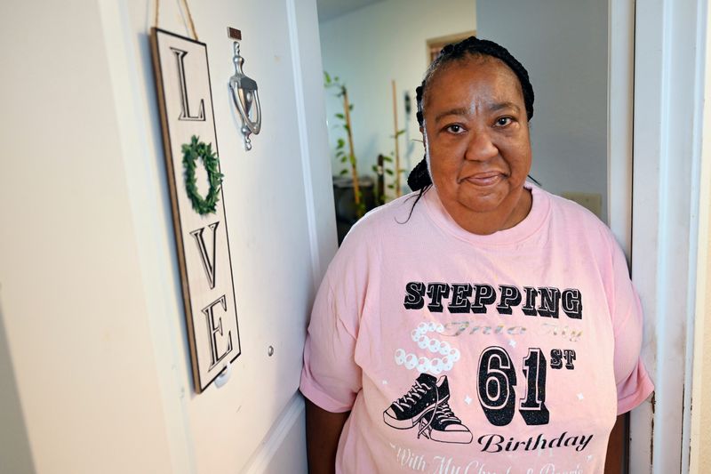 Harriett Whiting relaxes at her front door at the Village of University Meadows in Detroit in July. Whiting, 62, was thrilled to find housing she could afford after being displaced by fire at her previous residence. Across Metro Detroit, communities are working to expand housing options for older adults like Whiting.