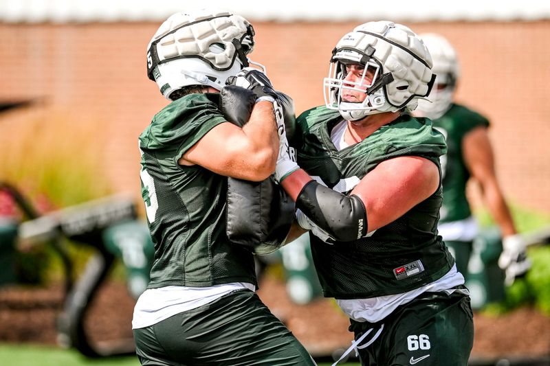 Michigan State's Ashton Lepo, right, and Charlton Luniewski run an offensive line drill during the first day of football camp on Tuesday, July 30, 2024, in East Lansing.