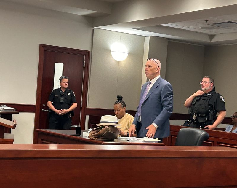 Defense attorney Steven Scharg, standing, with his client, Linda Polk, during her preliminary exam on murder and other charges in 41B District Court in Clinton Township on Aug. 1, 2025.