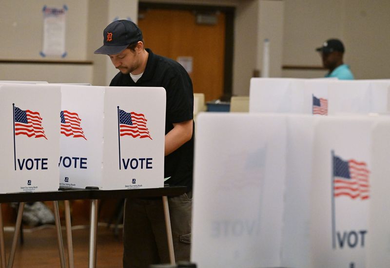 Tyrise Carey, 18, is cheered on by her mom Sharene Nathan and great grandad Charles Nathan after voting for the first time ever, in the Michigan primary at Northwest Activities Center in Detroit, Michigan on August 5, 2025.