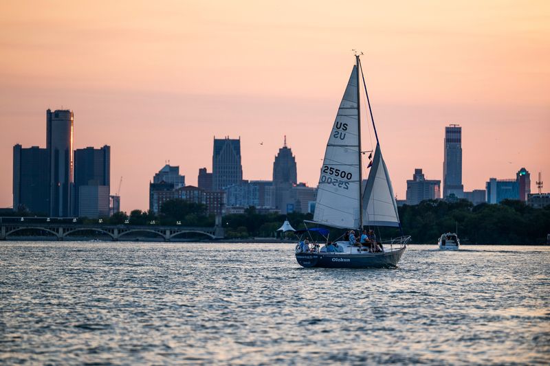 A sailboat floats past the downtown Detroit skyline on Friday, Aug. 1, 2025 in the Detroit River.