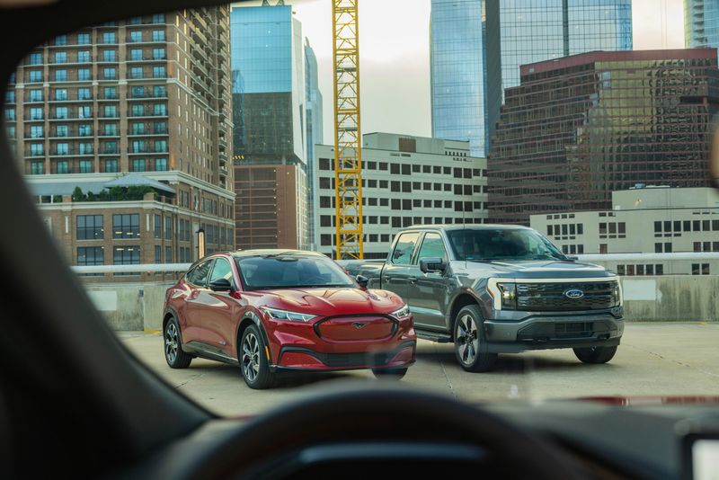 Two of the electric vehicles Ford Motor Co. sells: The Mustang Mach-E and the F-150 Lightning pickup.