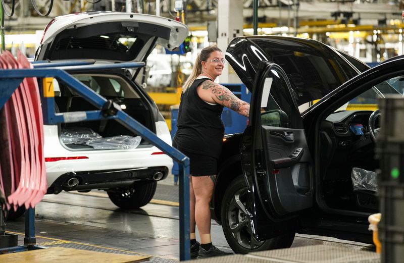 Ford workers at the Louisville Assembly Plant Monday morning, August, 11, 2025 where the giant auto and truck manufacturer announced plans to invest $5 billion and create roughly 4,000 jobs focused on EV production across the Louisville Assembly Plant and the BlueOval Battery Park in Michigan. The company touted the EV investment will create a new production line with a more comfortable work environment.
