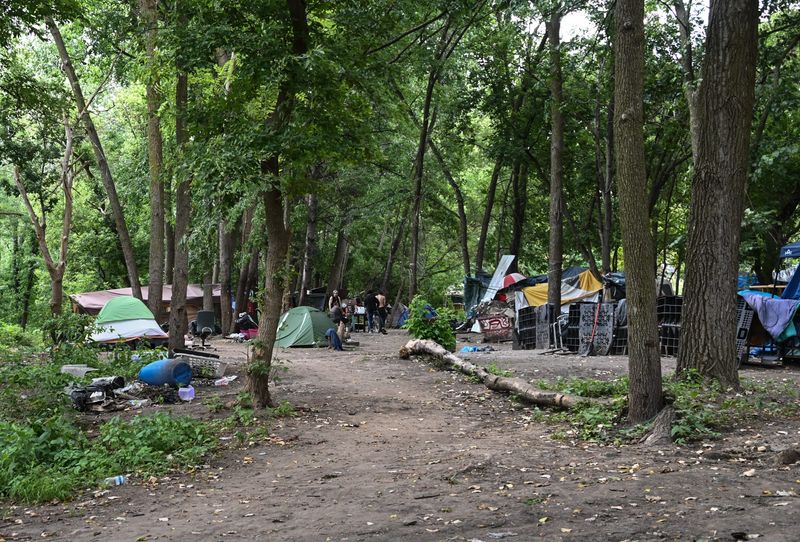 Campsites at a homeless encampment on private property just west of Dietrich Park in Lansing, pictured Monday, Aug. 11, 2025.