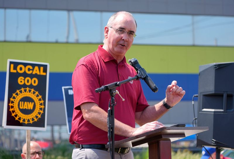 UAW president Shawn Fain talks with workers from Local 600 after they had marched on Thursday, August 14, 2025 from their headquarters on Dix in Dearborn to the Cleveland-Cliffs plant nearby where 600 workers are being laid off due to weak US auto production.