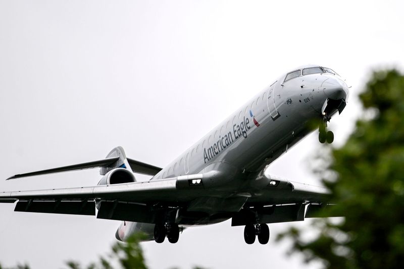 An airplane flies over the trees at Valley-Turner Park while landing at the Capital Region International Airport on Tuesday, Aug. 19, 2025, in DeWitt Township.