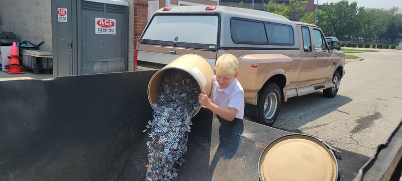 A child drops aluminum pull tabs into a donation bin at Ronald McDonald House Charities of Northwest Ohio. The Toledo-based organization and Ronald McDonald House Charities of Ann Arbor both accept donations of pull tabs.