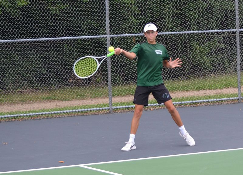 Hudson Badger plays at No. 1 singles for Pennfield during the season-opening match at Pennfield High School on Tuesday, Aug. 21, 2025.