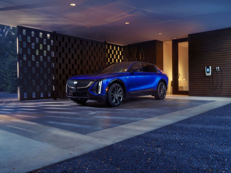 The 2026 Cadillac Lyriq Sport close to a home charging station.