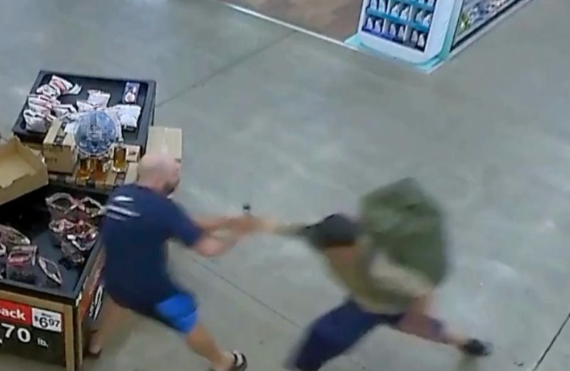 A man believed to be Bradford James Gille, right, is seen attacking a random shopper inside a Traverse City-area Walmart on July 26, 2025 in this video still frame from surveillance footage released by authorities.