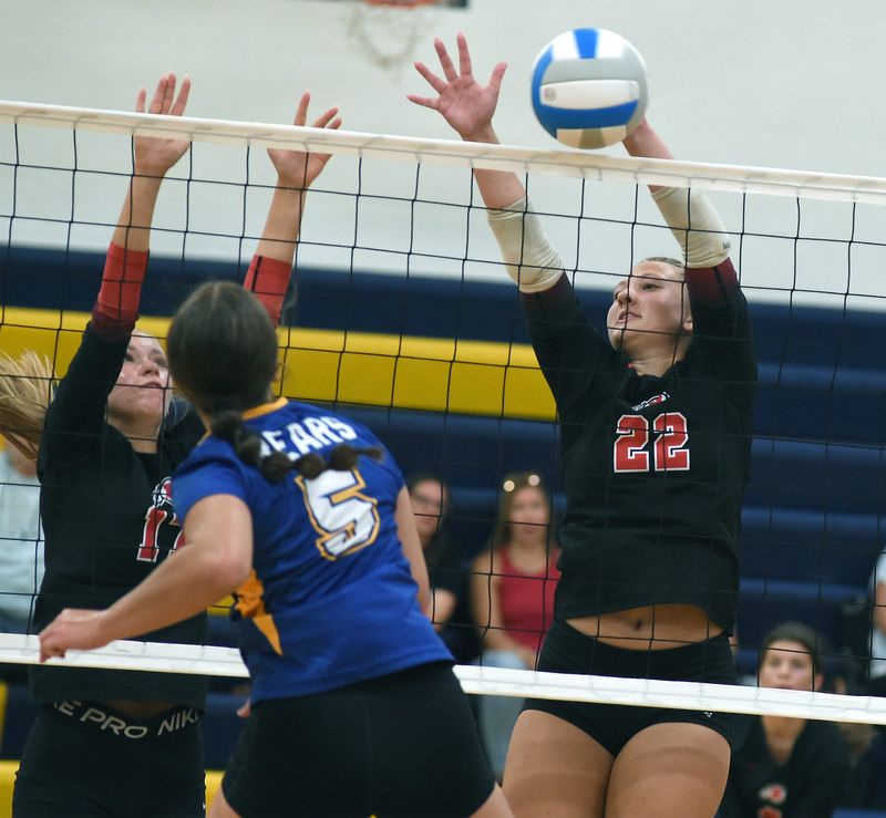 Addison McFadden of New Boston Huron goes up for a block over Jenna Flint of Jefferson during the Erie Mason Volleyball Invitational on Thursday, August 21, 2025.