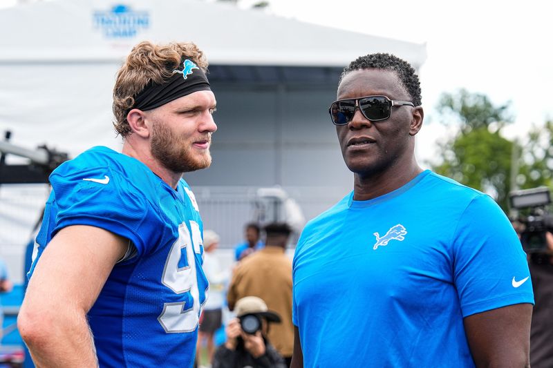 Detroit Lions defensive end Aidan Hutchinson (97), left, talks to former Lions player Robert Porcher after practice at training camp at Meijer Performance Center in Allen Park on Thursday, August 21, 2025.