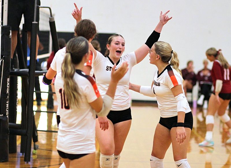 Nora Naliwajko (5) celebrates with several teammates following the Sturgis win over White Pigeon on Wednesday.